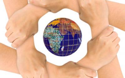 Image of Six Hands Locked Together in a Circle with the Earth in the Middle