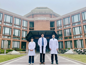 Group photo of investigators in front of the Medical Building, Tsinghua University