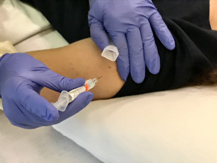 Volunteer in trial of candidate universal flu vaccine BPL-1357 receives an intramuscular injection.