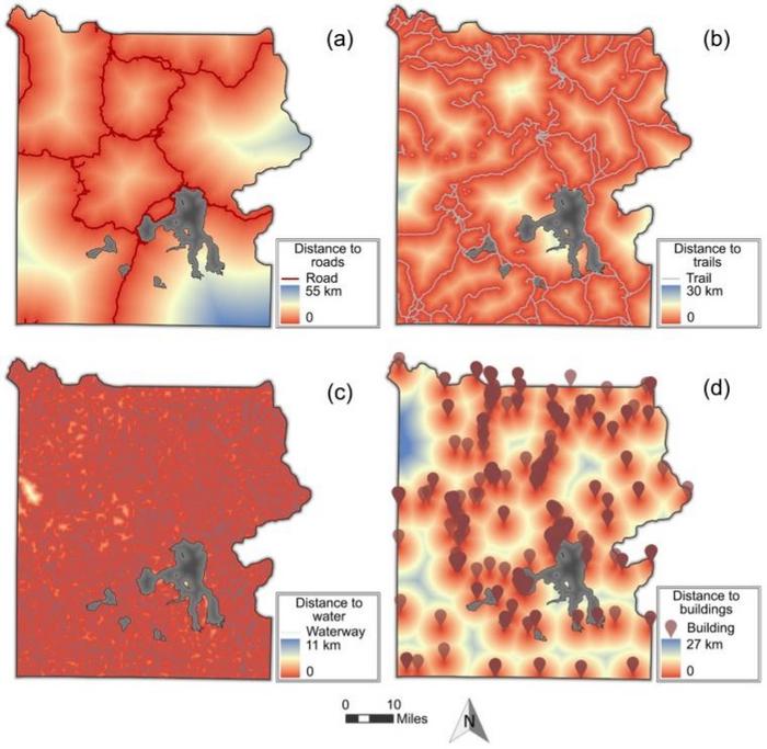 Output maps of the distance accumulation calculation from the point and line vulnerability criteria. (a) Distance to roads, (b) Distance to trails, (c) Distance to water, (d) Distance to buildings.