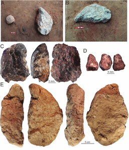 Artefacts lying on a red-stained sediment patch