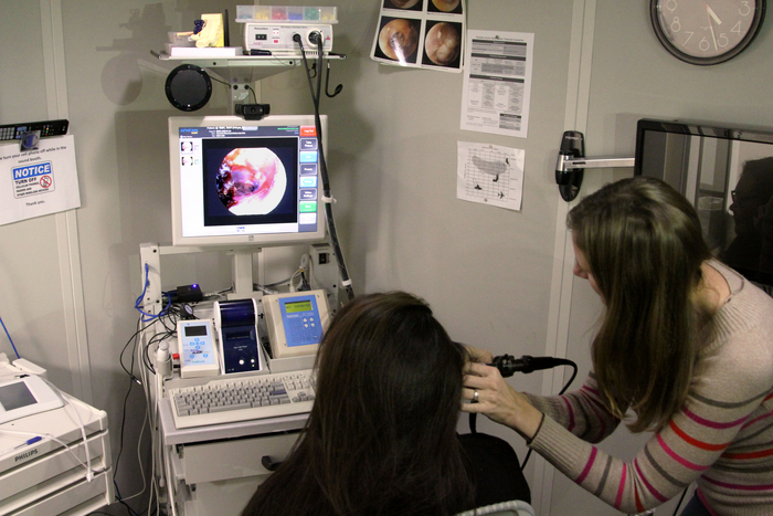 Robler taking a photo of an ear using a telemedicine cart