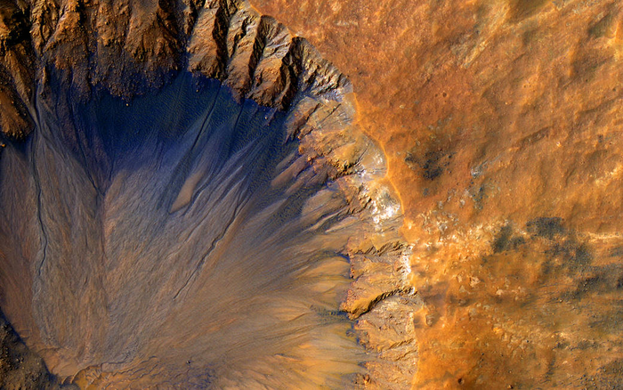 Crater in the Sirenum Fossae region on Mars, showing evidence of past water runoff.