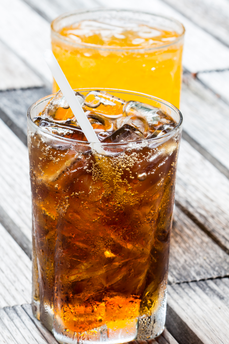 A glass of cola with ice cubes