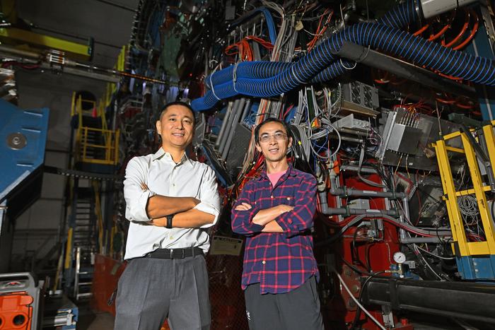 Jiangyong Jia and Shengli Huang in front of the STAR detector at RHIC