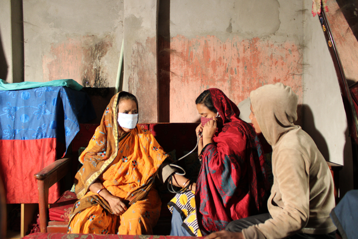 Sufia, grassroot organisation member, checking a patient with disabilities during the COVID-19 pandemic