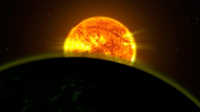 Artist concept of a star seen through the atmosphere of a planet orbiting it.