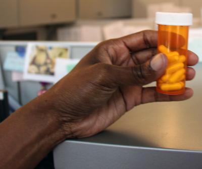 Hand Holding Vitamin D Pills