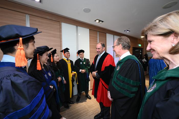 Professor Mary Klotman, Professor Thomas Coffman, and Guest-of-Honour His Excellency Mr Jonathan Kaplan speak to some graduands