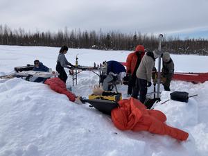 Sampling soil core near Fairbanks in winter