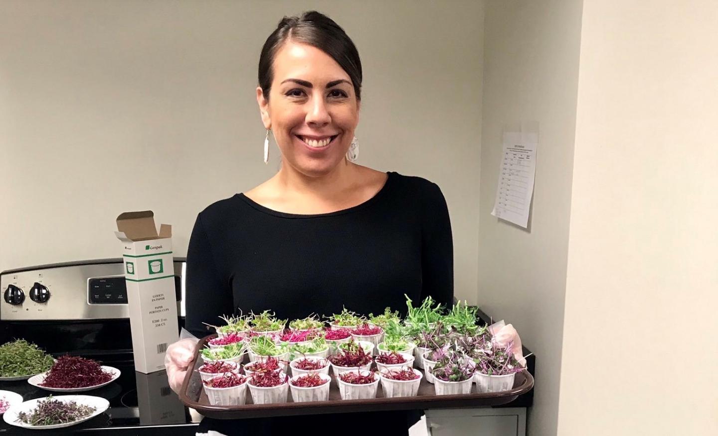 Sarah Ardanuy Johnson with microgreens