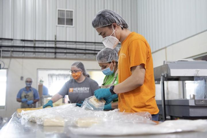Photo of students packaging cheese