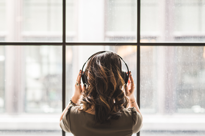Woman listening on headphones.