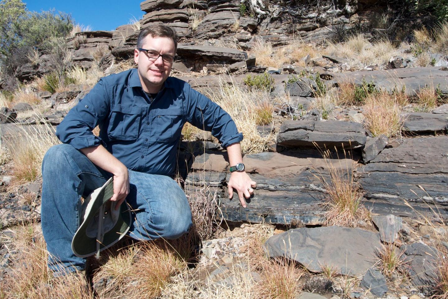 Professor Andrew Czaja Indicating the Rock Layers Where Fossils of Ancient Bacteria Were Found