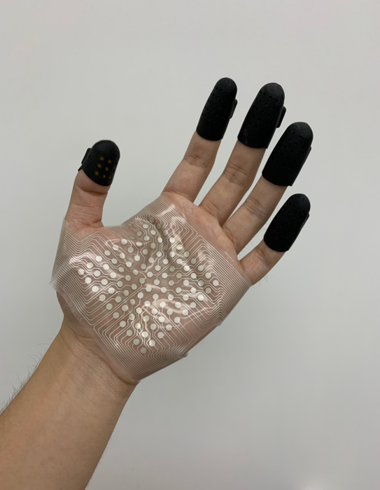 The new wearable tactile rendering system integrated into a set of finger cots