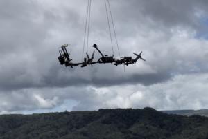 Collecting arm hanging from drone.