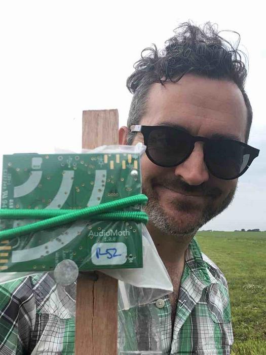 Researcher Adam Dixon with a bioacoustic recorder in the field