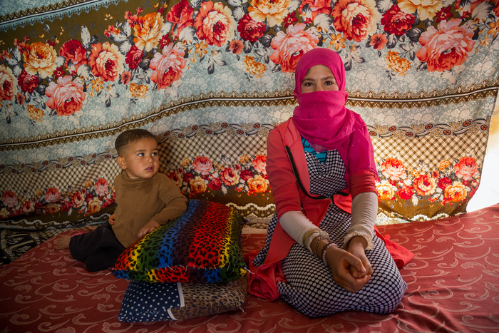 Young adolescent Syrian girl and her brother living in an informal tented settlement in Jordan