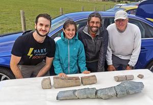 Part of the research team in 2020 examining the initial finds (at the back) of the new discovery made by Ruby and Justin Reynolds. Additional sections of the bone were subsequently discovered. From left to right, Dr Dean Lomax, Ruby Reynolds, Justin Reyno