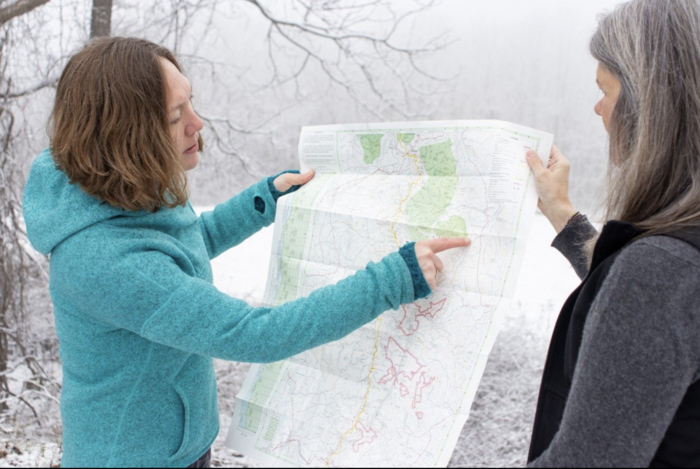 Emily Satterwhite (at left) points out areas of Appalachia on a map