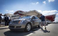 People Standing Next to Parked Cadillac SRX Driverless Car