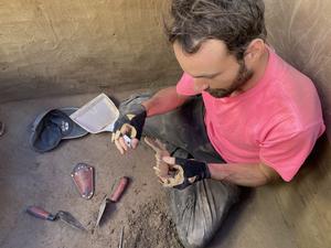 François Lanoë with 8,100-year-old canine mandible