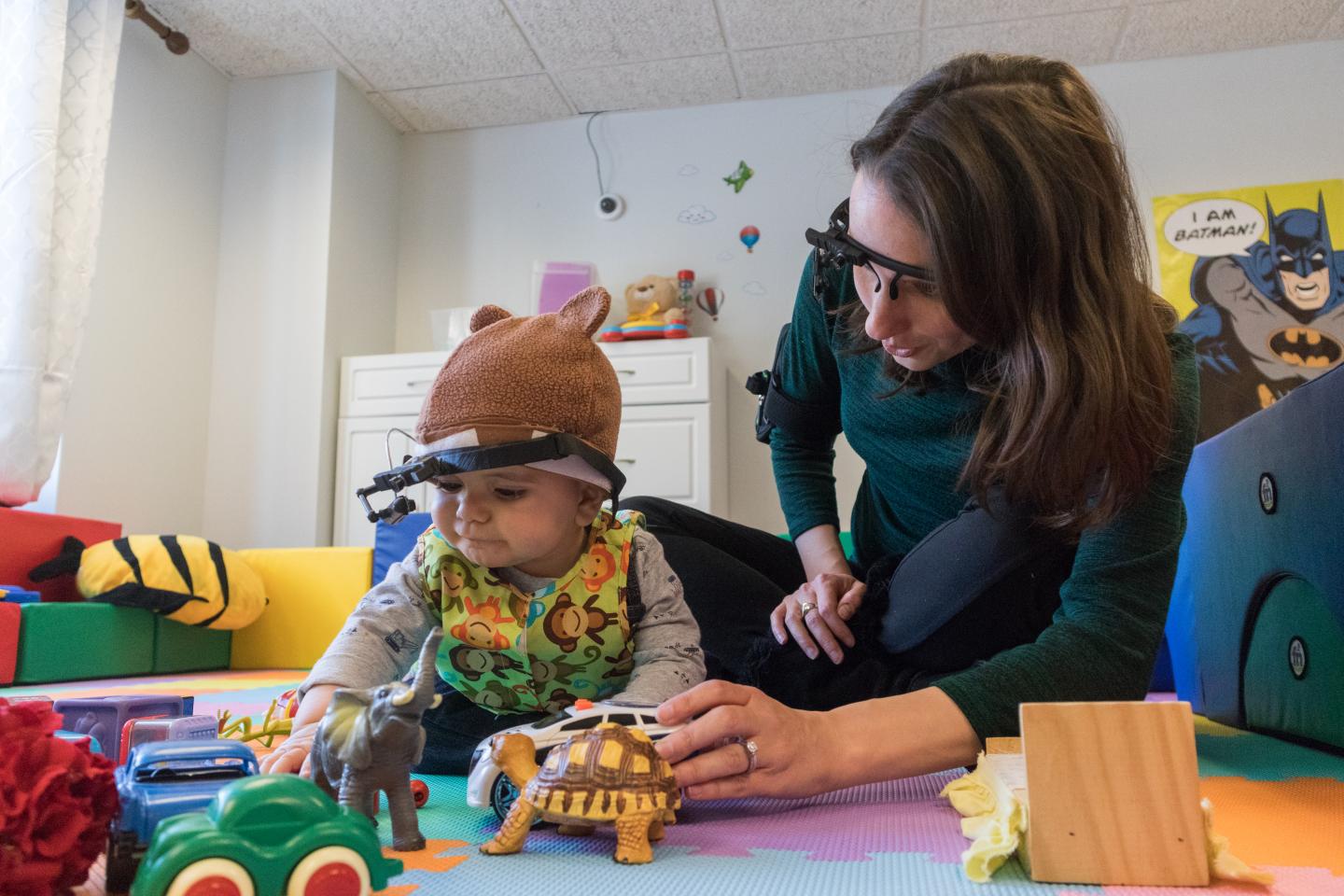 A Parent and Child Wear Eye-Tracking Devices while Playing on the Floor