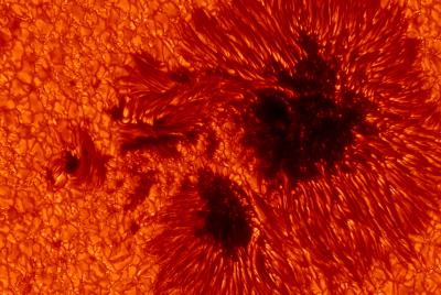 Dark Sunspots at the Visible Solar Surface