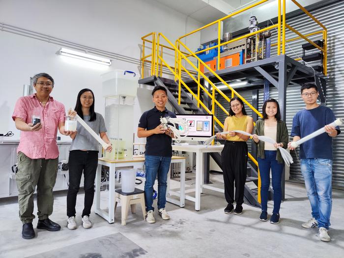 The joint team from Atera Water, NTU Singapore and SIT, with the membrane manufacturing plant in the background