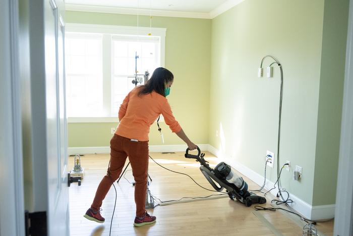 Researchers cleaning the house during testing