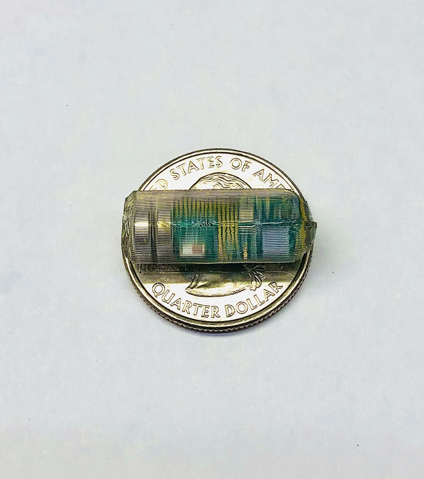 An ingestible electromagnetic device that could reveal the inner workings of the gastrointestinal tract on a coin for scale