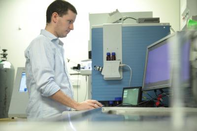 Ph.D. Student Sean Humphrey Working on a Mass Spectrometer (1 of 2)