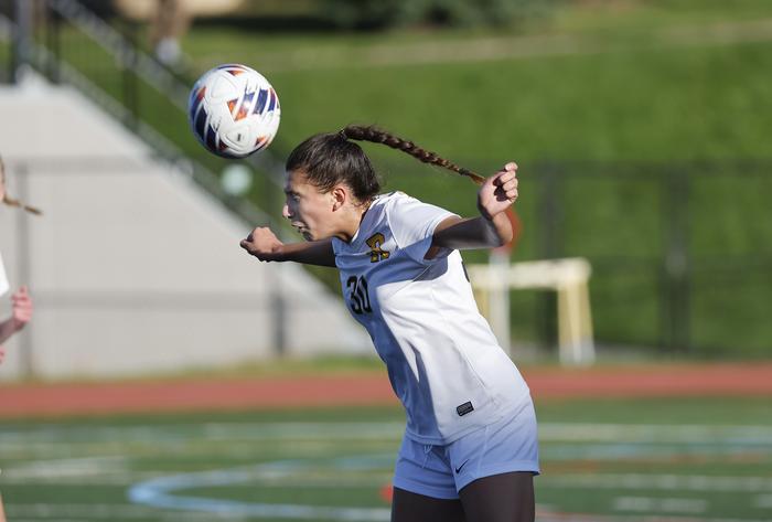 University of Rochester Soccer Player Heads Ball // Courtesy Rochester Athletics