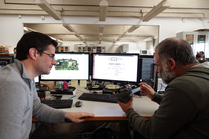 Both researchers showing the system prototype