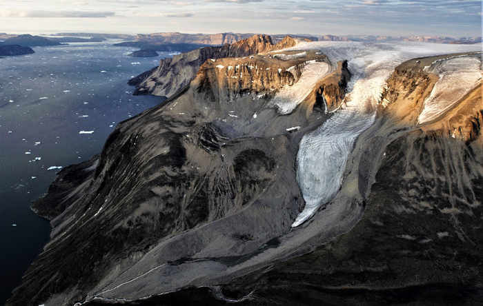 Glaciers sculpting the surrounding landscapes in Greenland.