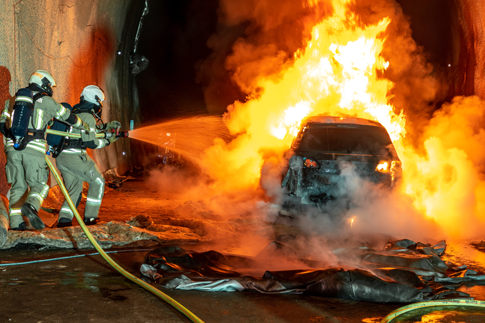 Firefighters extinguish vehicle fire