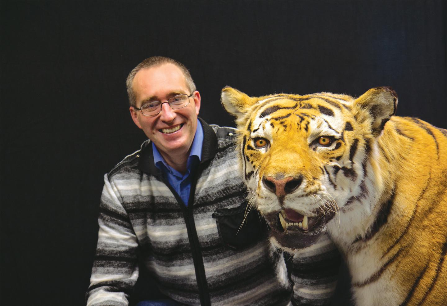 Researcher Mikhail Paltsyn with Taxidermied Tiger