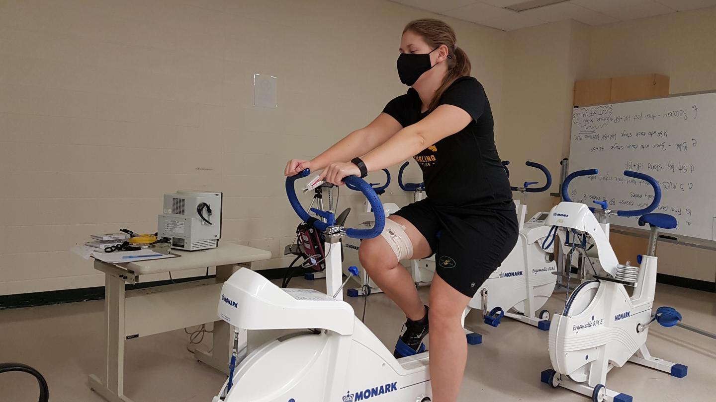 A Masked Study Participant on An Exercise Bike