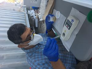 A member of the research team processes urine samples from farm workers