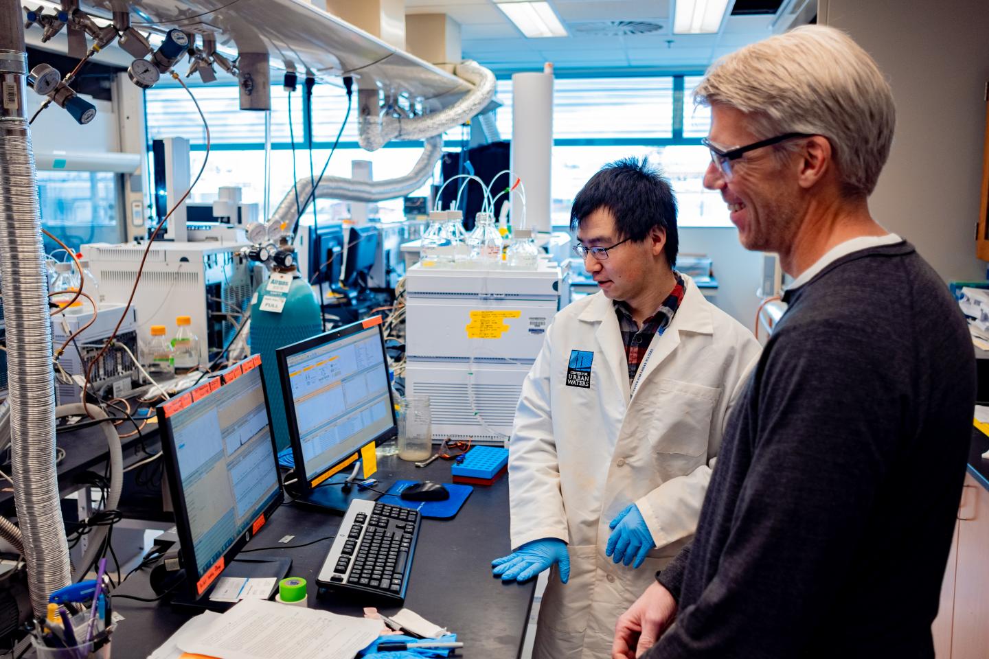 Zhenyu Tian and C. Andrew James examine mass spectrometry results