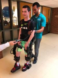 A young research participant training in the exoskeleton