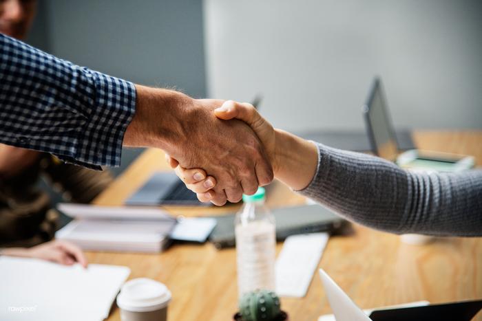 Business partners shaking hands at a meeting