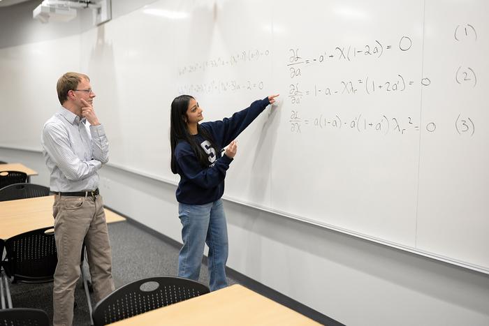 Penn State engineering graduate student at a whiteboard