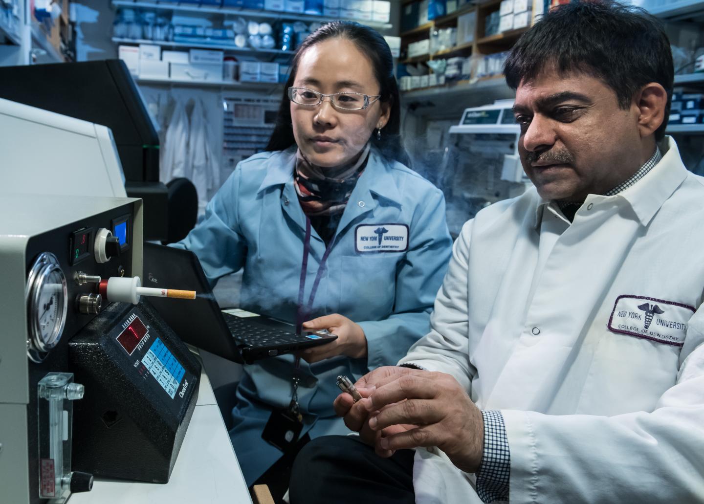 NYUCD Researchers Drs. Deepak Saxena and Xin Li Test the Study's 'Smoking Machine'