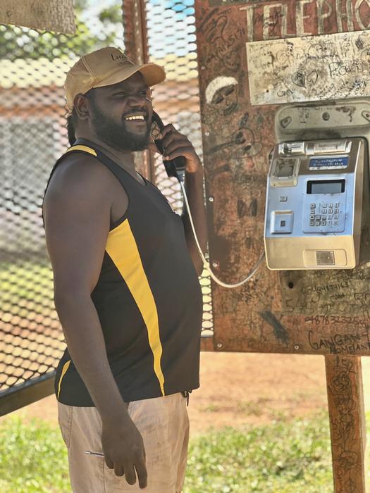 Gangan co-researcher Djamika Ganambarr uses the public phone which is the primary  means of phone communication for most Gangan residents