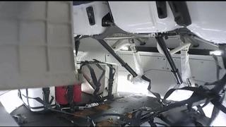 NASA astronaut Doug Hurley moves one of the student-built HUNCH lockers