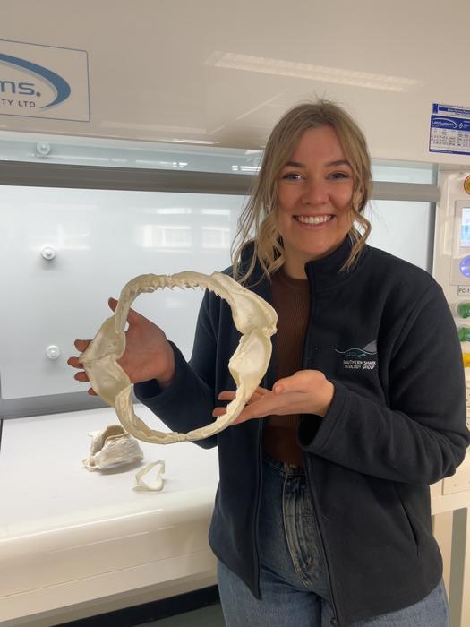 Laura Holmes and a Sevengill shark jaw