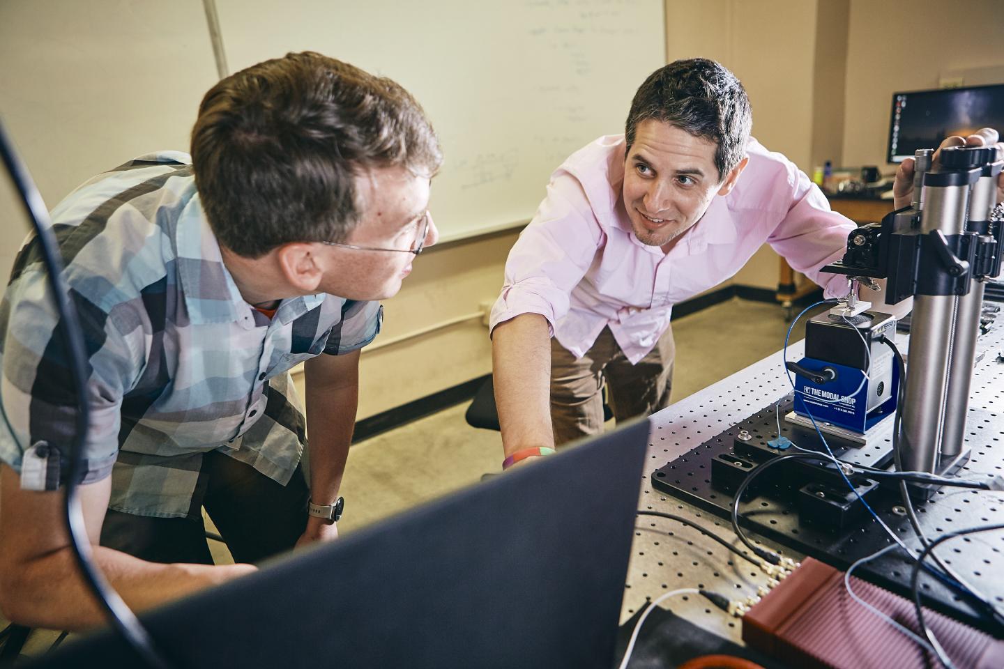Mechanical Engineering Researchers Mark Jankauski and Erick Johnson Converse in their Lab
