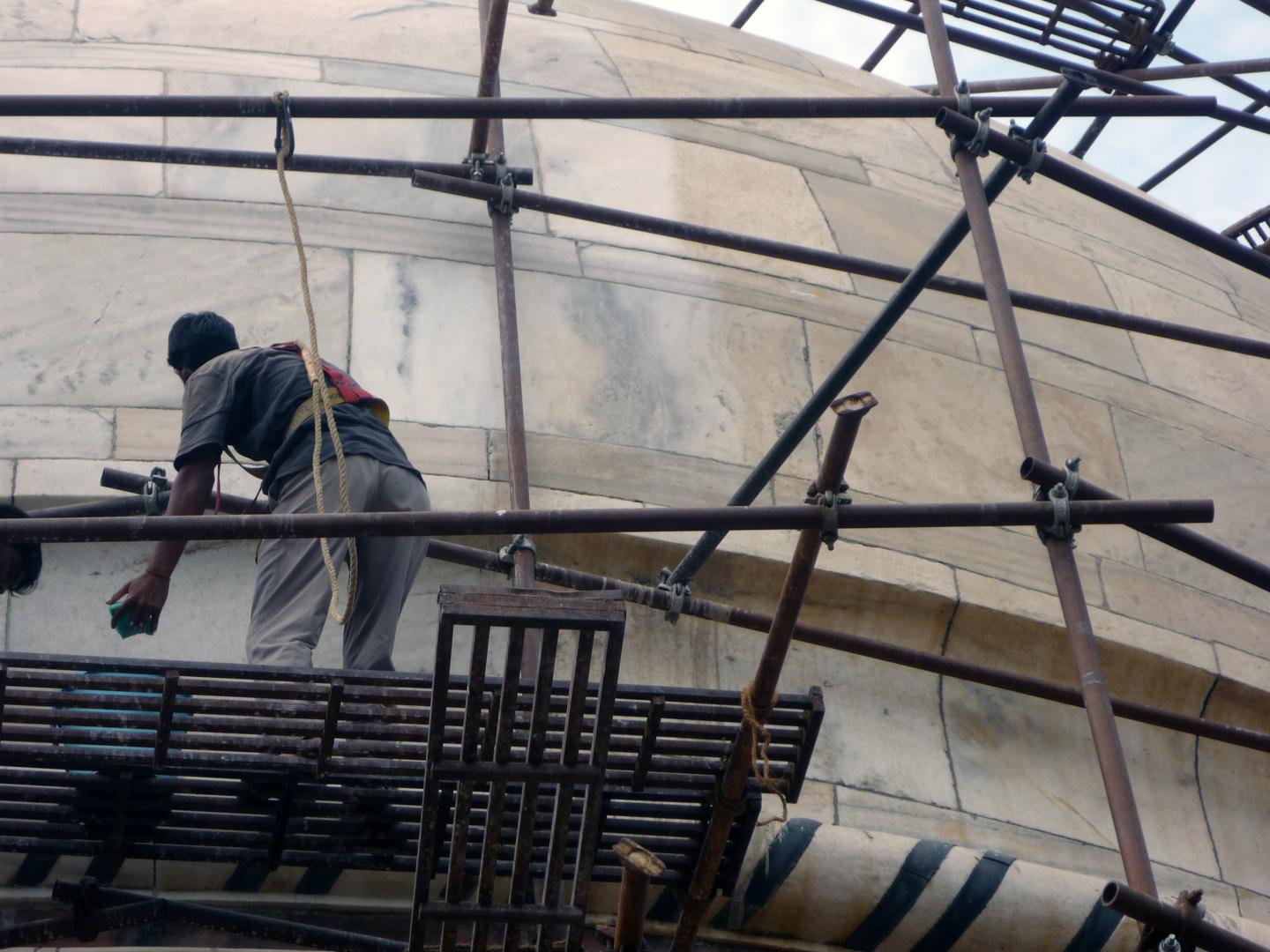 A Worker Cleans Particles at the Taj Mahal