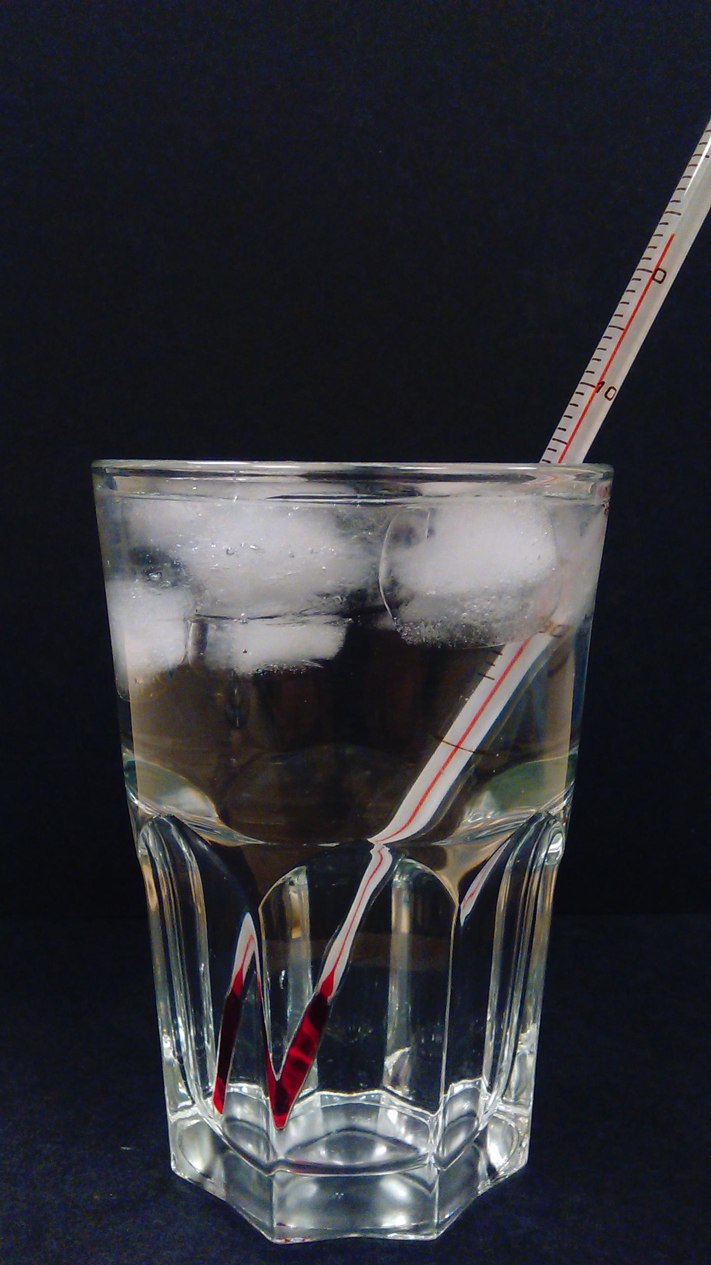 A Glass of Ice Water with a Thermometer Measuring 4 Degrees C at the Bottom